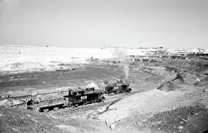 Mucha: Locomotives pull wagons to load ore