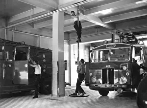 London firefighters sliding down a pole