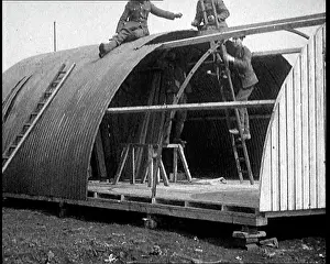 Ladders: Long Shot of the Nissen Hut Under Construction
