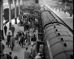 Embarking: Looking Down Along a Train Platform With Passengers