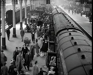 Embarking: Looking Down Along a Train Platform With Passengers