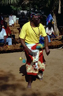 Xylophone: Magenge, one of four rattle players, playing Njele