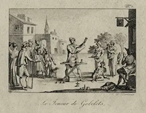 Trickery: Magician performing the cup and balls trick to an assembled