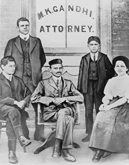 Experiencing: Mahatma Gandhi seated, surrounded by four ?