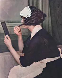 Applying: Maid applying lipstick