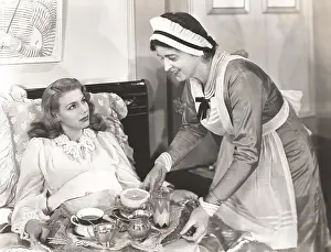 Pamper: Maid serving breakfast to woman lying in bed