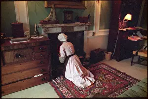 Kneels: MAID TENDS TO FIRE