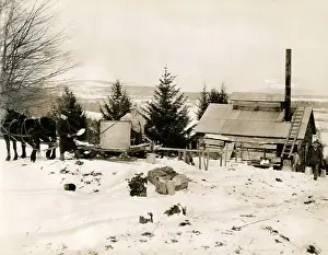 Syrup: Making maple syrup on a farm in Canada in the snow, c.1920's