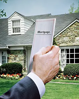Mortgage: Male Hand Holding Mortgage Document