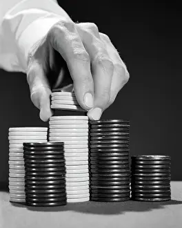 Tokens: Male Hand Picking up Poker Ships from Stack to