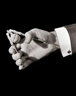 Cracking: Male Hands Cracking Walnut with Metal Hand-Held