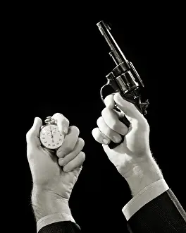 Signa: Male Hands Holding a Stop Watch and a Starting