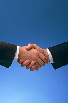 Businesspeople: Male Handshake Against Blue Background