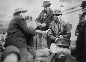 Steerage: Male immigrants at mess on the deck of the