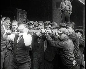 Stuntman: A Male Stuntman Bending Iron Bars Around His Head