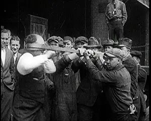 Stuntman: A Male Stuntman Bending Iron Bars Around His Head