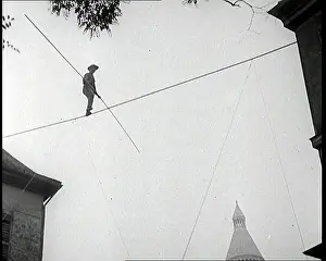 Montmartre: A Male Stuntman Walking a Tightrope Between