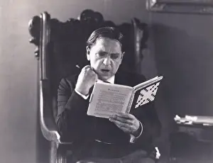 Crossword: Man absorbed in crossword puzzle