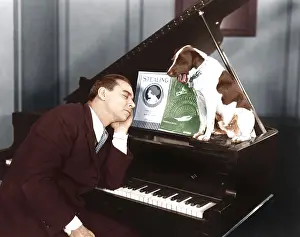 Napping: Man asleep at piano with dog