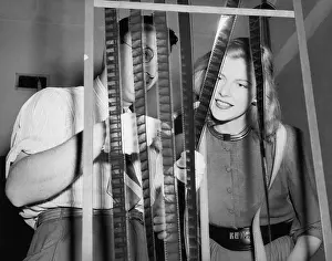Examinations: Man with his assistant looking at film reels