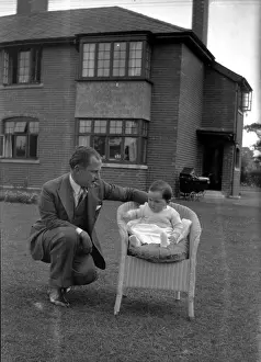 Detached: Man and baby in a garden