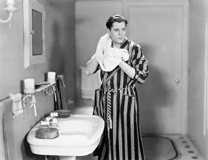 Bathrooms: Man in the bathroom drying his neck