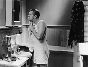 Bathrooms: Man at bathroom mirror