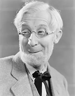 50 60: Man with beard and glasses making a silly face