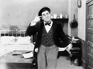 Impoverished: Man in his bedroom putting his hand like a gun to