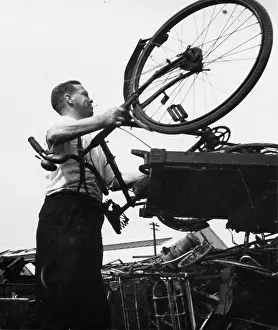 Junkyard: Man with a bicycle in a junk yard
