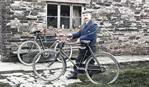 Significantly: Man with bicycles outside house