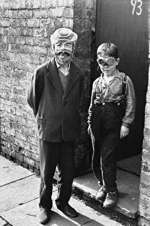 Braces: Man and boy in costume at the back yard gate
