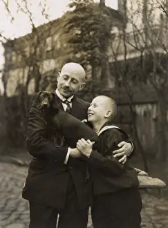 Dachshunds: Man and boy holding a dachshund