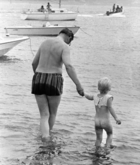 Paddling: Man and boy paddling in the sea