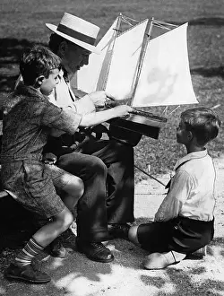 Hobby: Man and boys with a model of a ship, 1930s