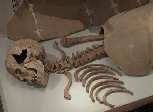 Amphora: Man buried beneath the two halves of an amphora