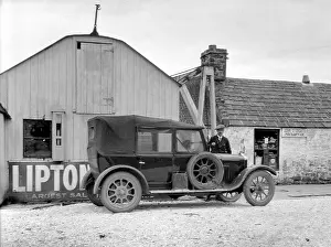 Northernmost: Man and car outside Post Office, John o'Groats, Scotland