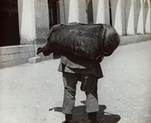 Burden: Man carrying a heavy weight
