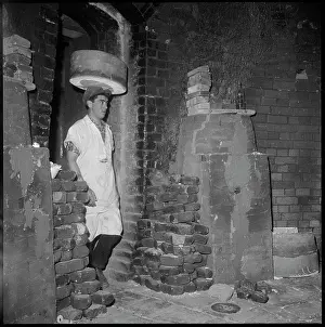 Parsonage: A man carrying a saggar on his head through the