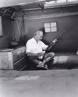Wiping: Man cleaning his rifle