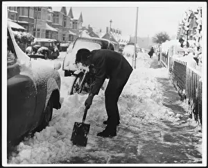 Clearing: MAN CLEARS SNOW