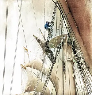Man climbing rigging of sailing ship