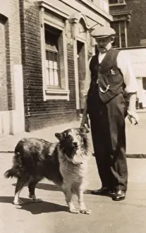 Shirtsleeves: Man with a collie dog in a street