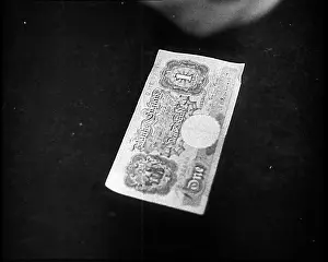 Demobilising: A Man Counting Out Notes on a Table To Pay