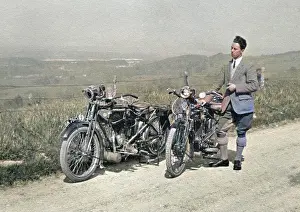 Man on country lane with two motorbikes