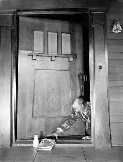 Hangover: Man crawling at the front door to reach his newspaper