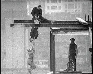 Plank: Man Dangling By His Feet From A Plank Suspended