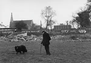 Walkies: Man and dog in a grassy area, Manchester