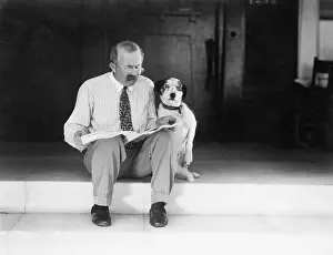 Mustaches: Man and dog sitting on the steps reading the newspaper
