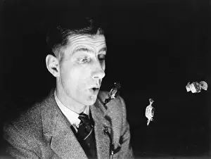 Robin Adler: Man doing a magic trick with sweets